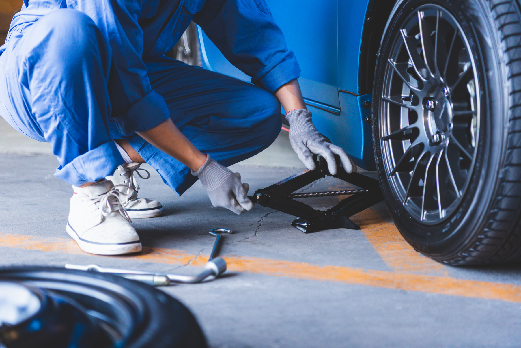 A rescue technician changing a wheel at the roadside